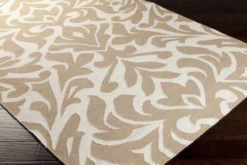 Close up of a Searles Area Rug in ivory and tan with a contemporary floral design. Hand woven wool texture. Corner