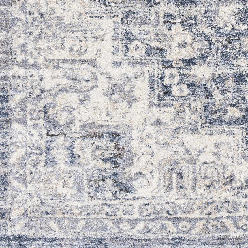 Close-up of the Shotts Thick Luxe Rug. Machine woven rug in cream, light gray, and dark blue with traditional oriental pattern. Swatch