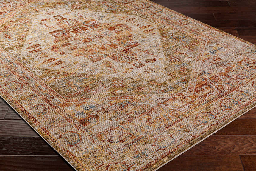Close-up of the Alois Tan Rich Textured Traditional Rug showing bone, clay, and walnut colors on dark wood flooring. Corner