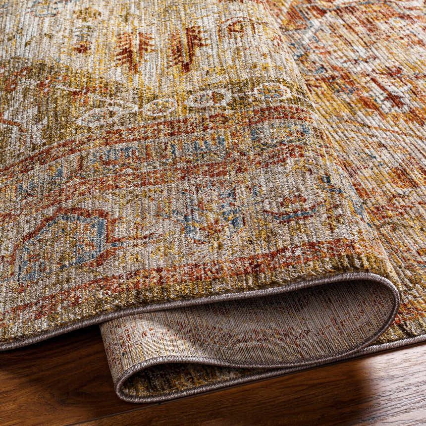 Close-up of the Alois Tan Rich Textured Traditional Rug showing bone, clay, and dark gray colors. Fold