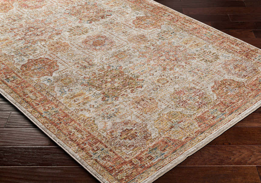 Close-up of the Ange Rust Rich Textured Traditional Rug showing its bone, clay, and dark brown floral pattern. Corner