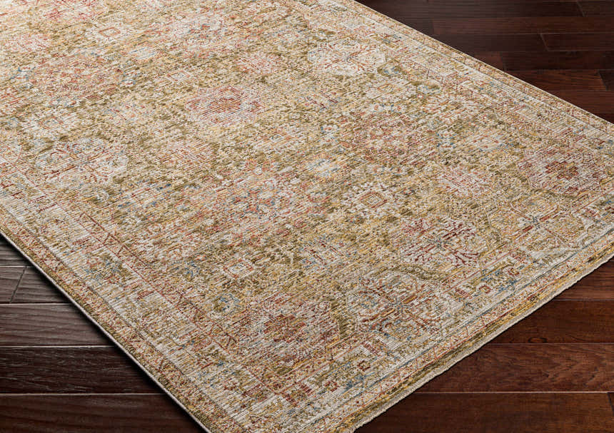 Close-up of the Ange Tan Rich Textured Traditional Rug showing bone, clay, and walnut colors on dark wood floor. Corner