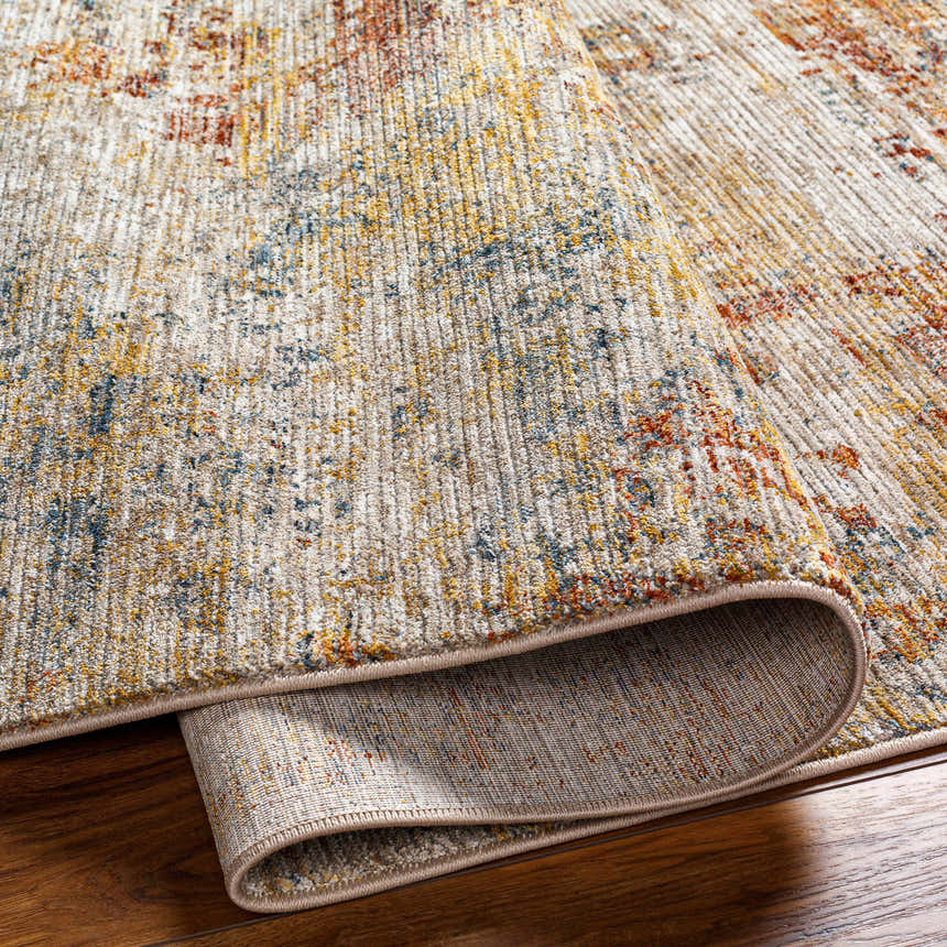 Close-up of the textured Chas Tan rug. Features bone, clay, dark gray, walnut, and white thatch colors. Fold