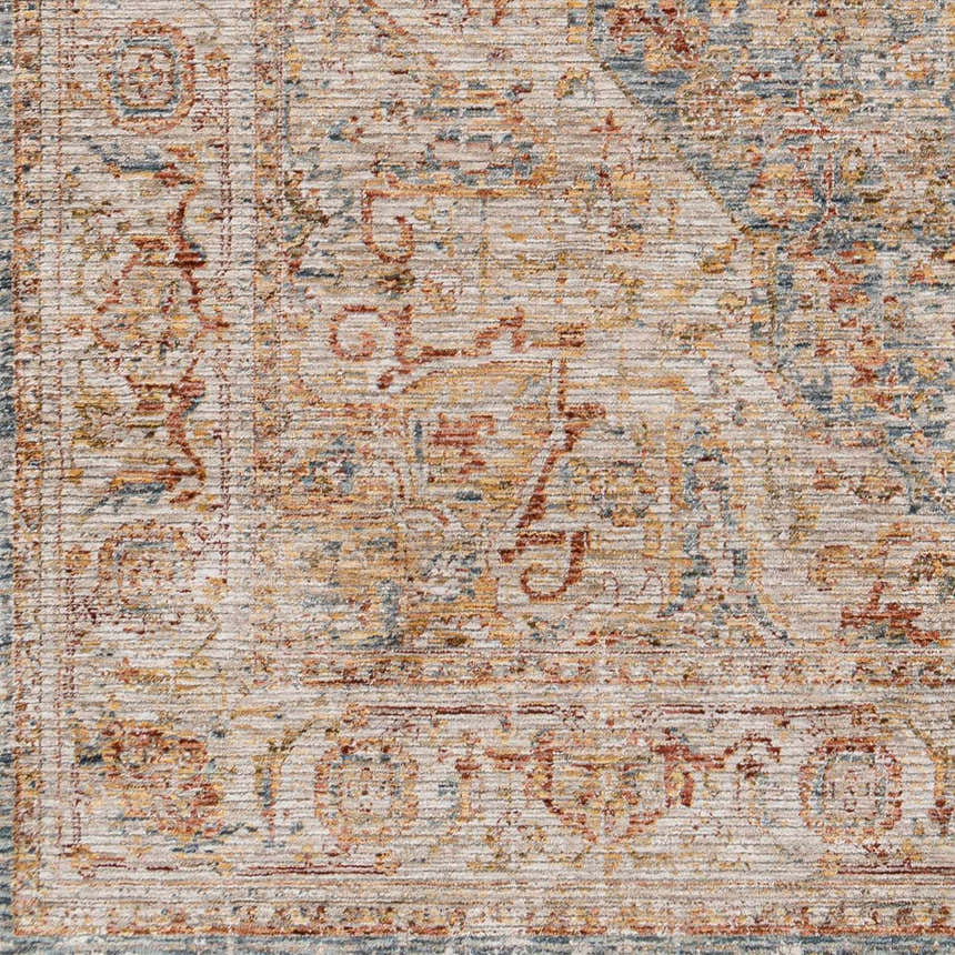 Close-up of the Cress Tan Rich Textured Traditional Rug, showing bone, blue, and rust colors in a farmhouse style pattern. Swatch
