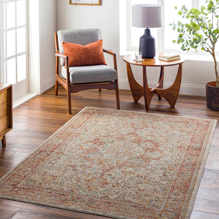 Living room scene with Cress Rust rug, gray chair, wood table, and warm, inviting decor. Roomscene-Rectangle