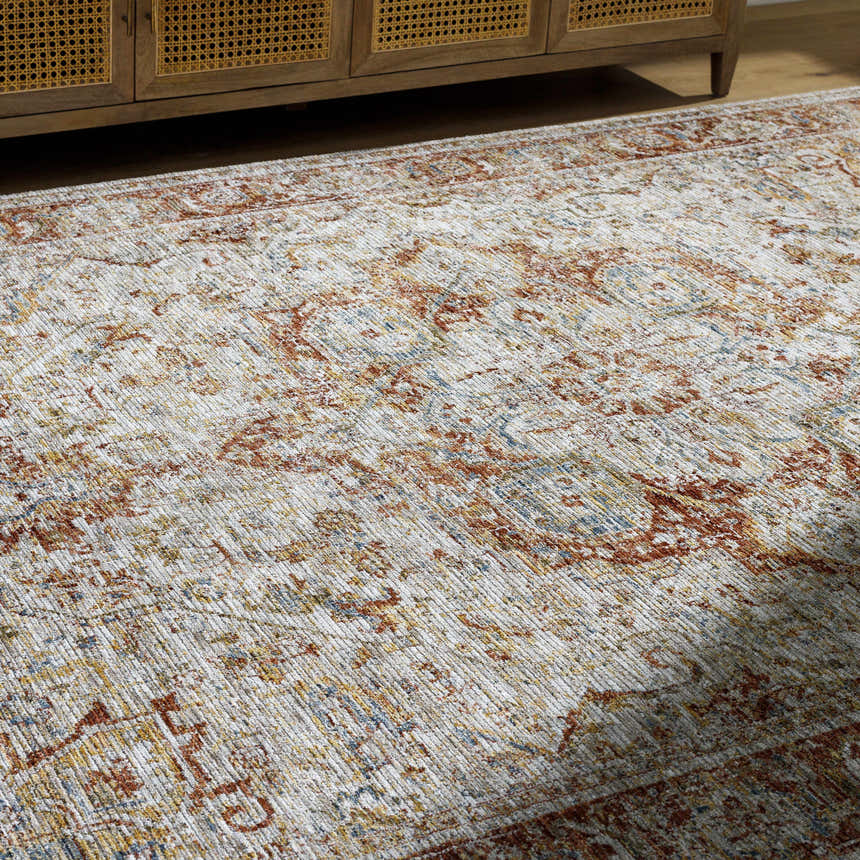 Close-up of the rich texture and traditional pattern of the Cress Rust rug with clay, brown, and peach tones. Styleshot
