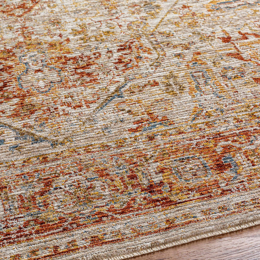 Close up of the rich textured Cress Rust Traditional Rug, showing clay, brown, and peach tones. Texture