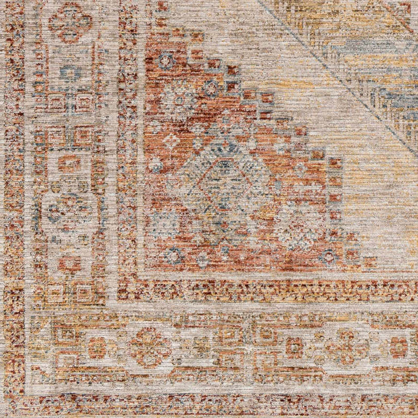 Close-up of the Moya Tan rug showing its rich texture, traditional pattern, and colors like bone, clay, and dark brown. Swatch