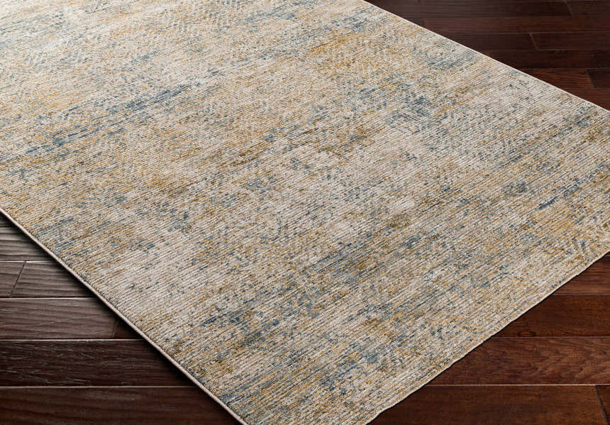 Close-up of the textured Sava Tan Rich Textured Rug showing bone, taupe, and dark brown colors on dark wood flooring. Corner