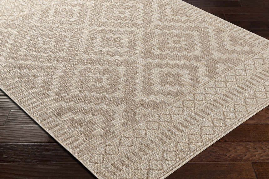 Close up of the Sitangkai Indoor & Outdoor Rug in cream and tan, showcasing its geometric pattern and polypropylene texture. Corner
