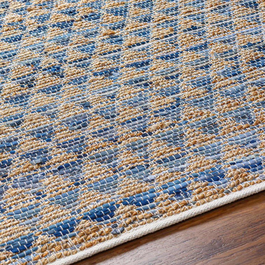 Close-up of the hand woven Colm Recycled Blue Jean Rug, showing the blue and tan pattern and texture. Texture