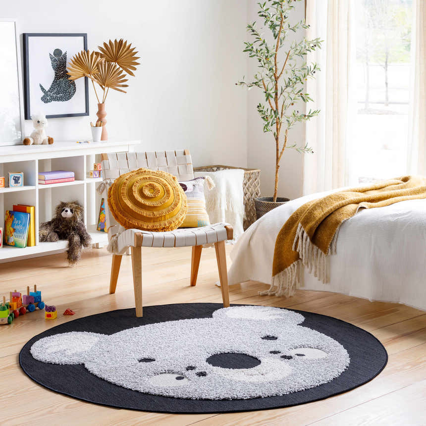 Kids room scene with a Koala Animal Print Nursery Area Rug, chair, toys, and a bed. Roomscene-Round