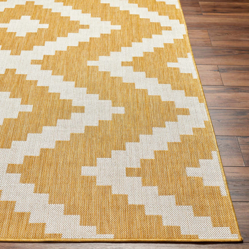 Close up of the Anke Yellow Area Rug showing a geometric, beige and yellow pattern on wood floors. Front