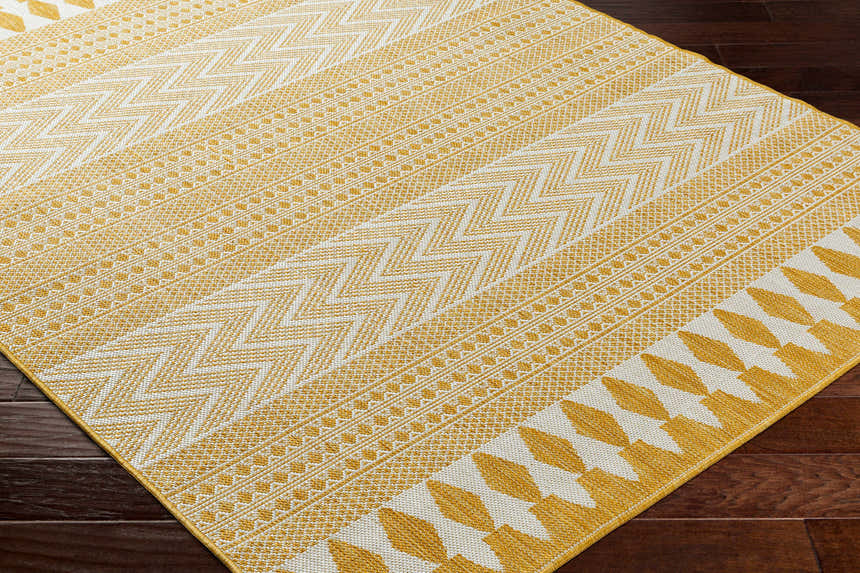 Close-up of Asif Mustard Area Rug showing its beige and mustard geometric pattern and woven texture. Corner