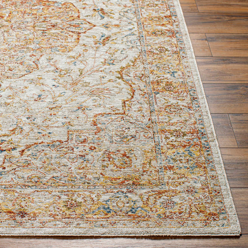 Close-up of the Aman Beige Area Rug showing its traditional design, brick red, mustard, and navy colors on a wood floor. Front