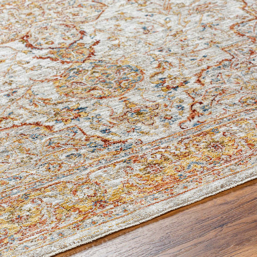 Close-up of the Aman Beige Area Rug showing its traditional pattern in brick red, mustard, navy, and light sage colors. Texture