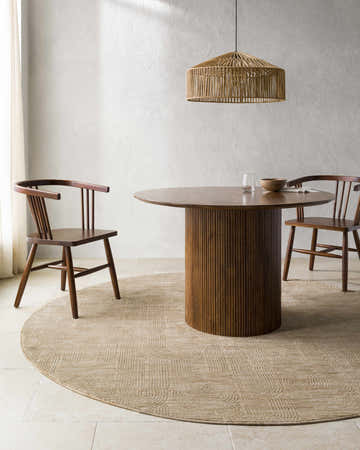 Dining room with a round wood table and chairs on a round Harva Tan Area Rug. Woven pendant light overhead. Roomscene-Round