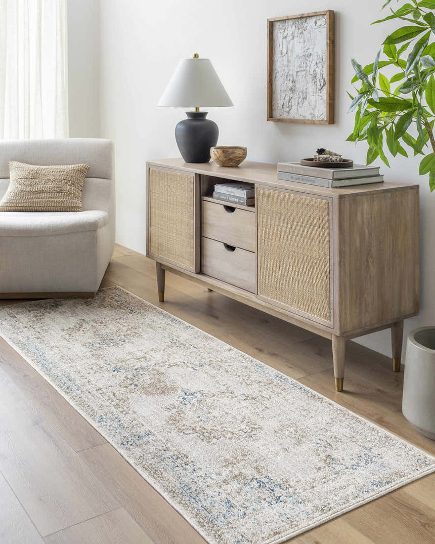 Living room scene with Kosta Beige & Blue Medallion Area Rug, light wood floors, console table, and neutral chair. Roomscene-Runner