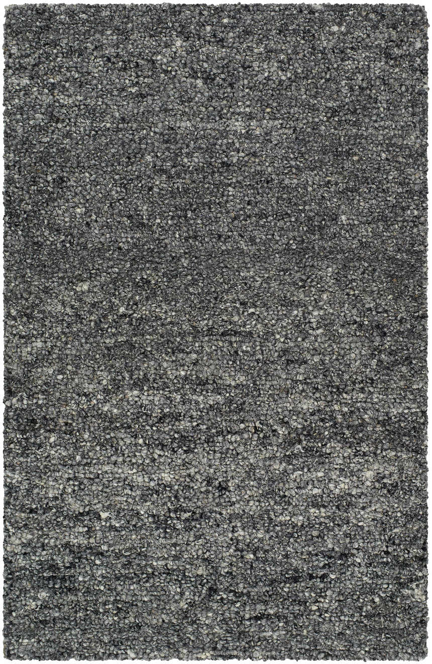 Close-up of the Sevan Charcoal Wool Area Rug. Hand-tufted rug with a looped texture in shades of black, gray, and steel gray. Design-Rectangle-23
