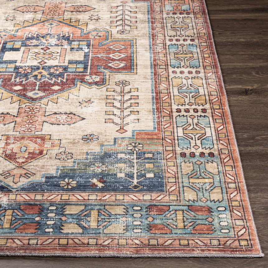 Close-up of the Snell Area Rug showing its traditional, Southwestern-inspired pattern and amber, brick red, and blue colors. Front