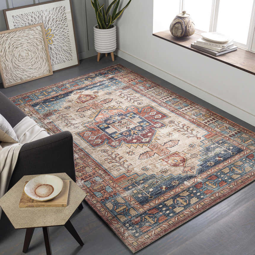 Living room scene with a Snell Area Rug in amber, brick red, and blue, styled with a gray sofa and modern decor. Roomscene-Rectangle
