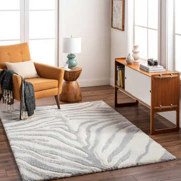 Living room scene with a Dysis Gray Zebra Print Area Rug, ochre chair, wood console, and bright natural light. Roomscene-Rectangle