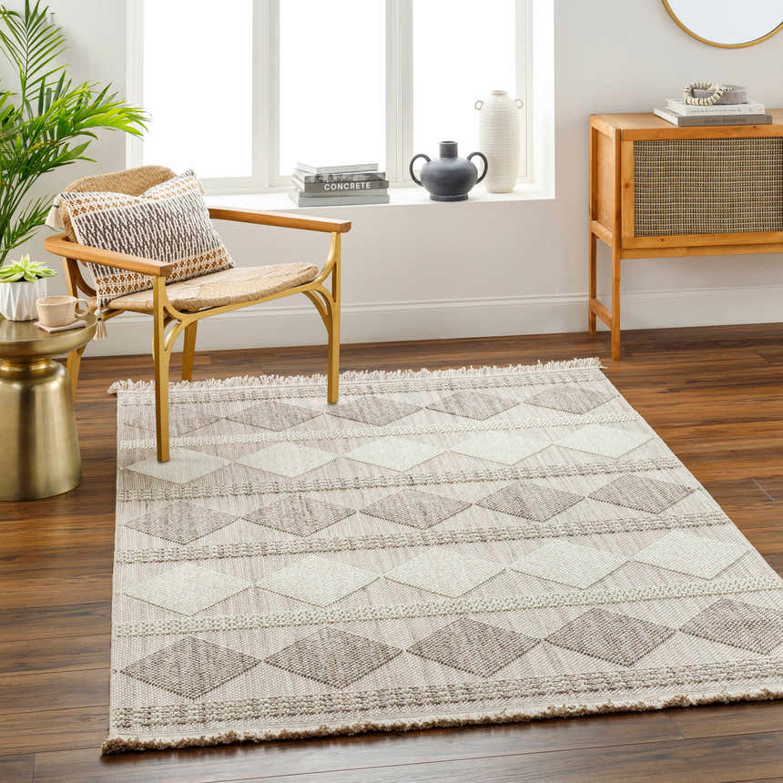 Living room scene with a beige Igone Area Rug, woven chair, wood cabinet, and neutral decor. Farmhouse style. Roomscene-Rectangle