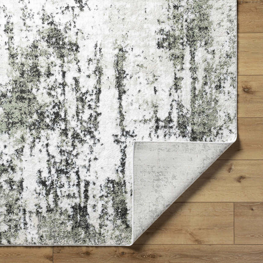 Close-up of the Omari Area Rug, light gray polyester with a contemporary abstract design, on a wood floor. Fold