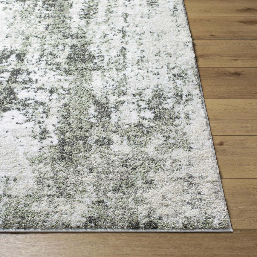 Close-up of the light gray Omari Area Rug showing its contemporary design and soft texture on a wood floor. Front