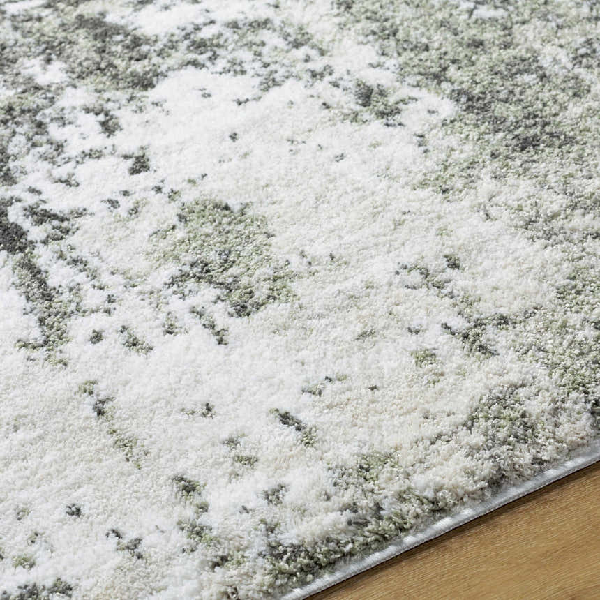 Close-up of the light gray Omari Area Rug, featuring a contemporary abstract pattern and soft polyester texture. Texture