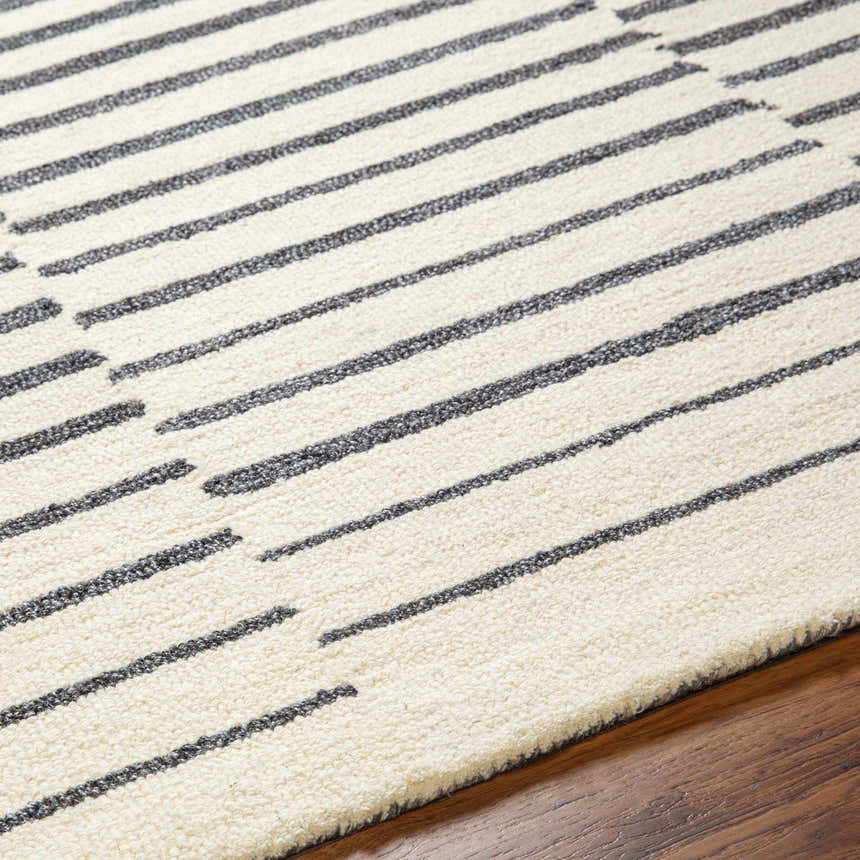 Close-up of Gawel Charcoal Area Rug showing beige wool and dark gray striped contemporary design. Texture