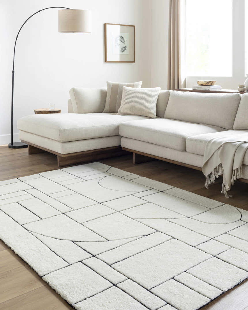 Living room with a cream sectional sofa and Fusao Rose Cream Area Rug featuring a geometric design. Roomscene-Rectangle