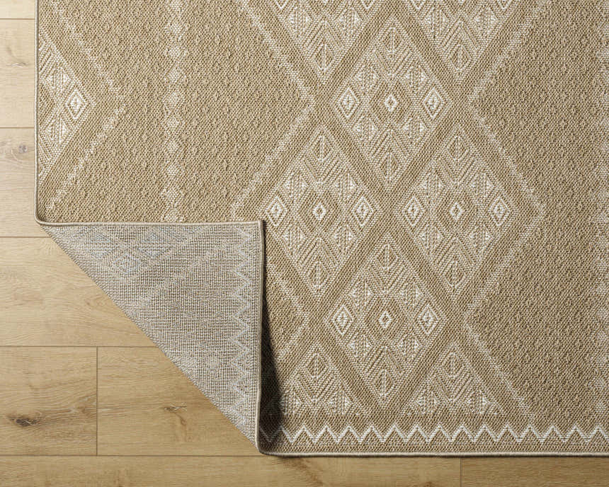 Close-up of the Olina Flatweave Faux Jute Rug in khaki and tan, showing diamond pattern and texture on wood floor. Fold