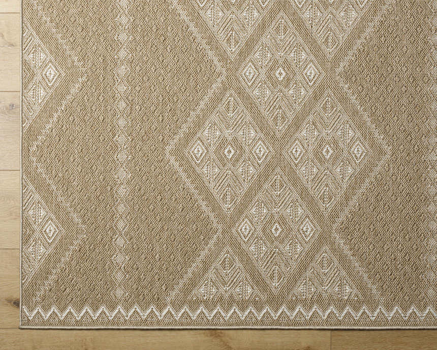 Close-up of the Olina Flatweave Faux Jute Rug. Khaki and tan rug with a diamond pattern and a flatweave texture. Corner