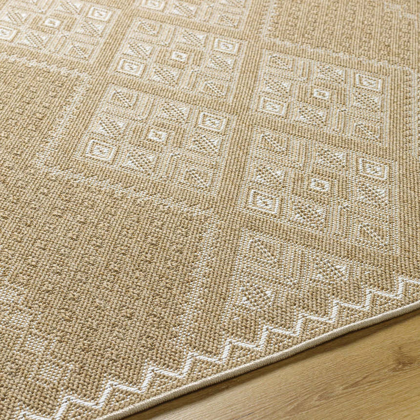 Close-up of the Olina Flatweave Faux Jute Rug. Khaki and tan rug with a geometric pattern and a zig-zag border. Texture