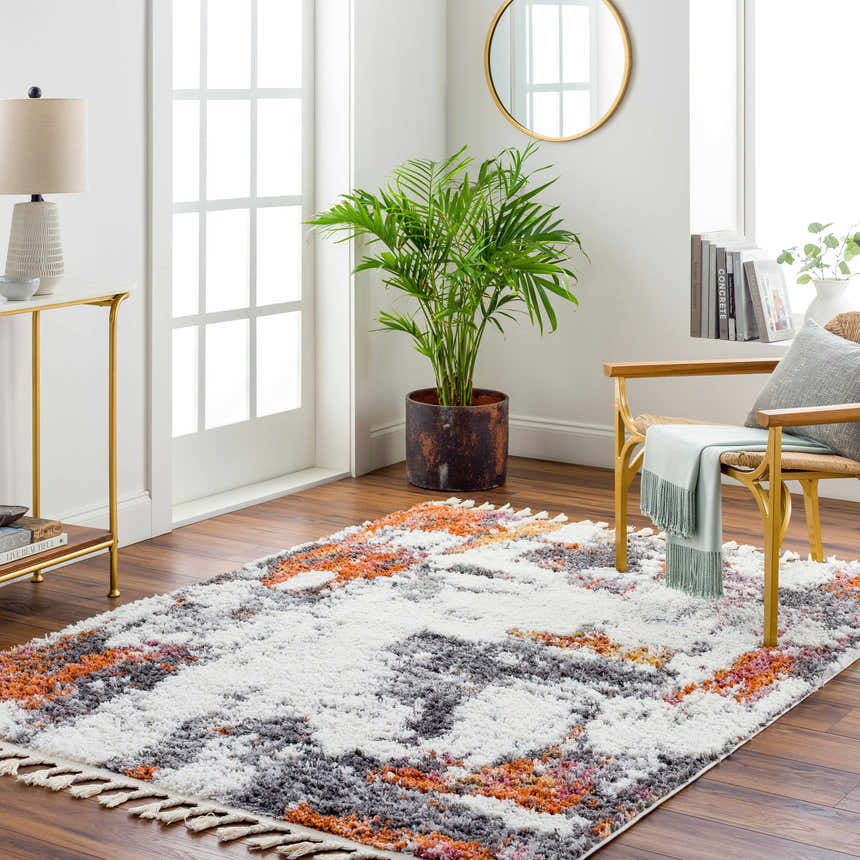 Living room scene with a Shep Area Rug in dark beige, brown, lambswool, and smoke colors. Roomscene-Rectangle