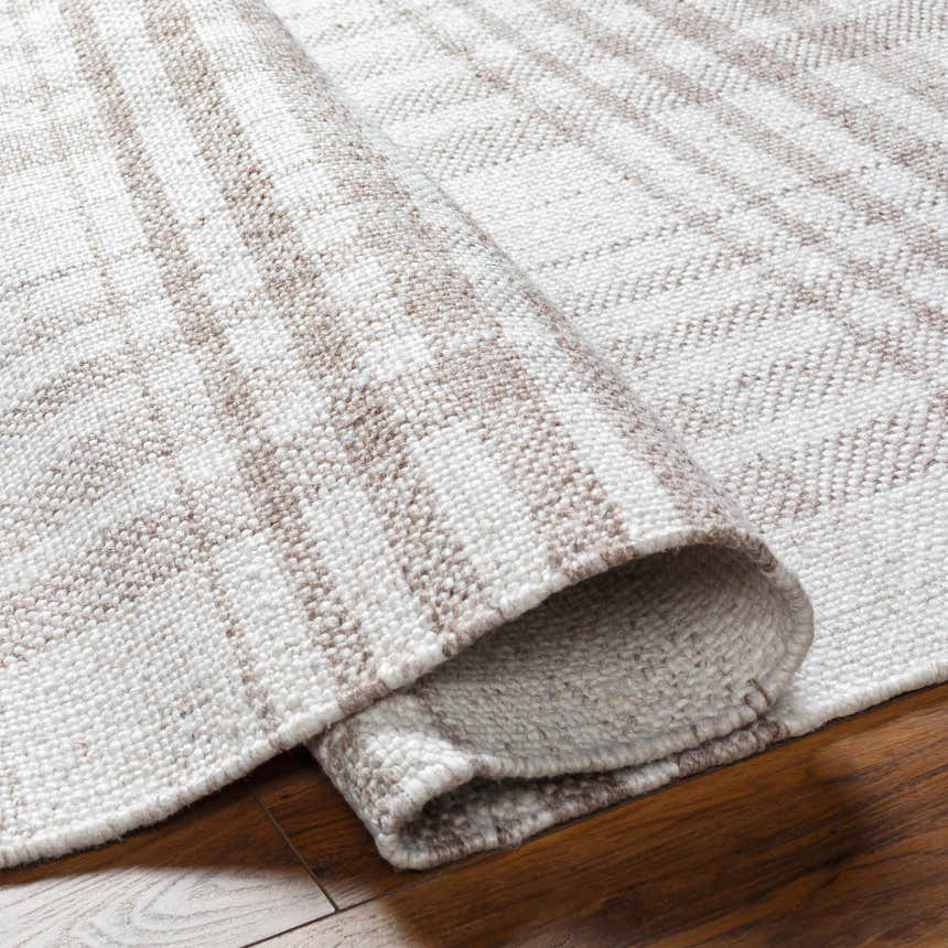Close-up of the Inara Light Brown Plaid Hand Woven Area Rug showing its beige and brown plaid pattern and hand woven texture. Fold
