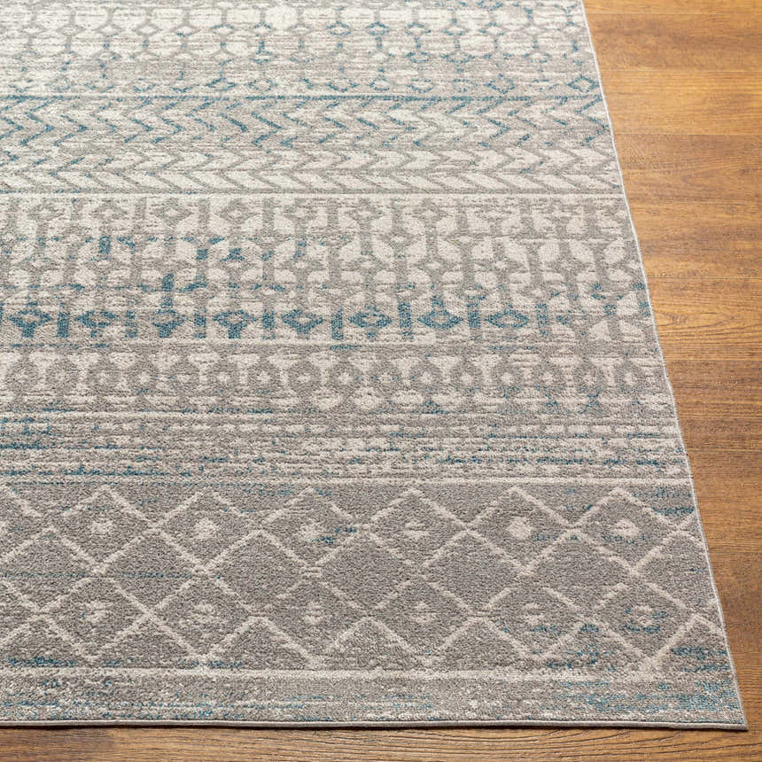 Close-up of Tambac Blue & Gray Washable Area Rug showing geometric pattern and texture on wood floor. Front