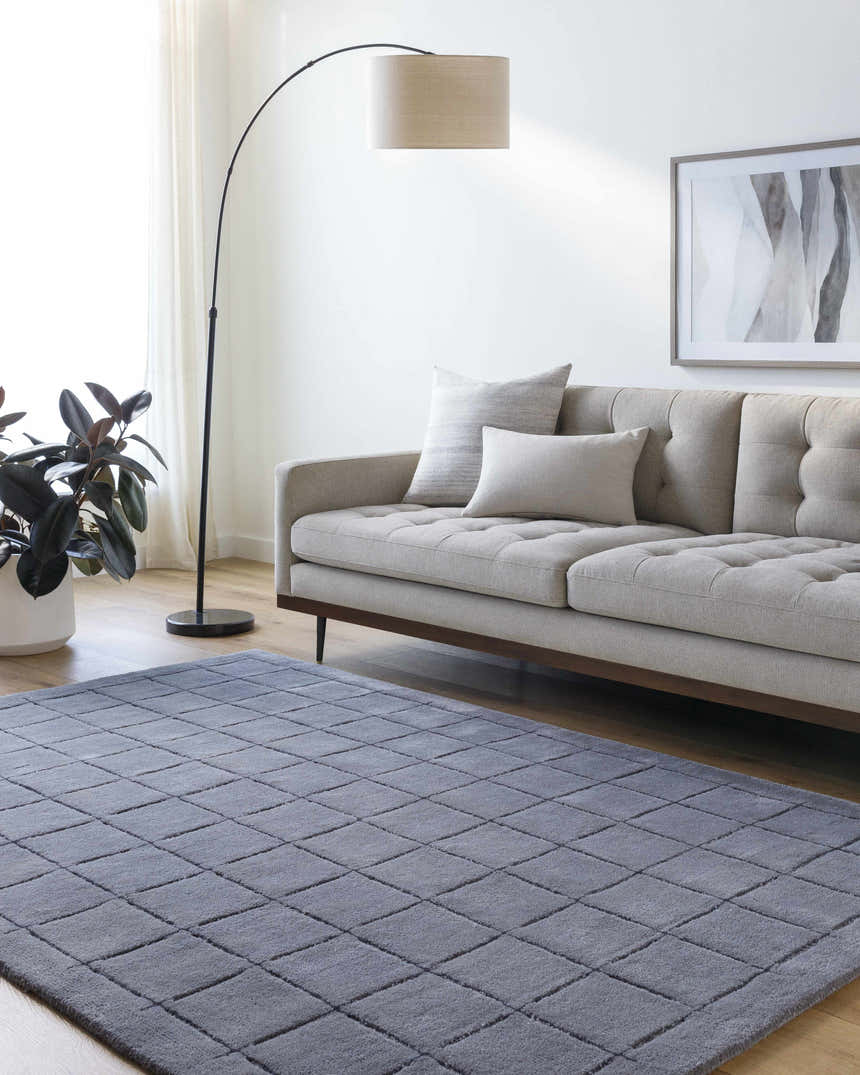 Living room scene with a gray sofa and the charcoal Sanvi Area Rug with a geometric pattern. Roomscene-Rectangle