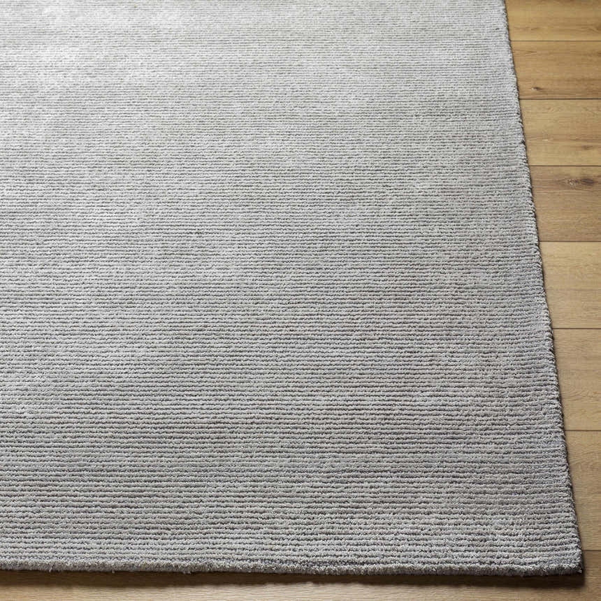 Close up of the silver gray Noham Area Rug showing hand tufted texture and horizontal lines. Front