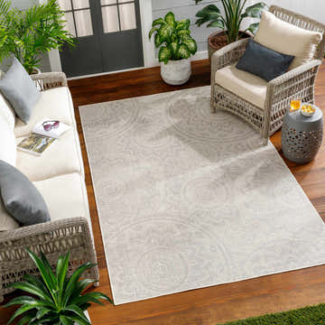 Patio scene with wicker furniture and Ayala Cream Area Rug on wood floor. Roomscene-Rectangle