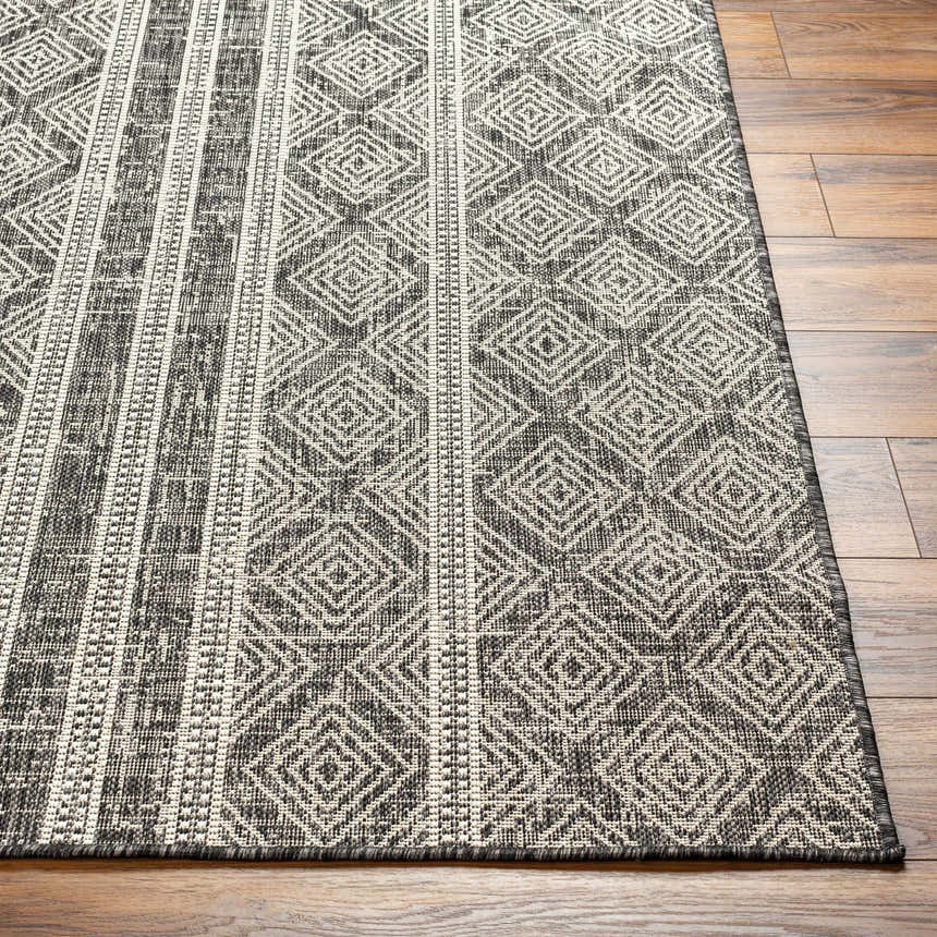 Close-up of the Gavin Nutmeg Area Rug showing its geometric diamond pattern and stripes in beige, bone, and gray tones. Front