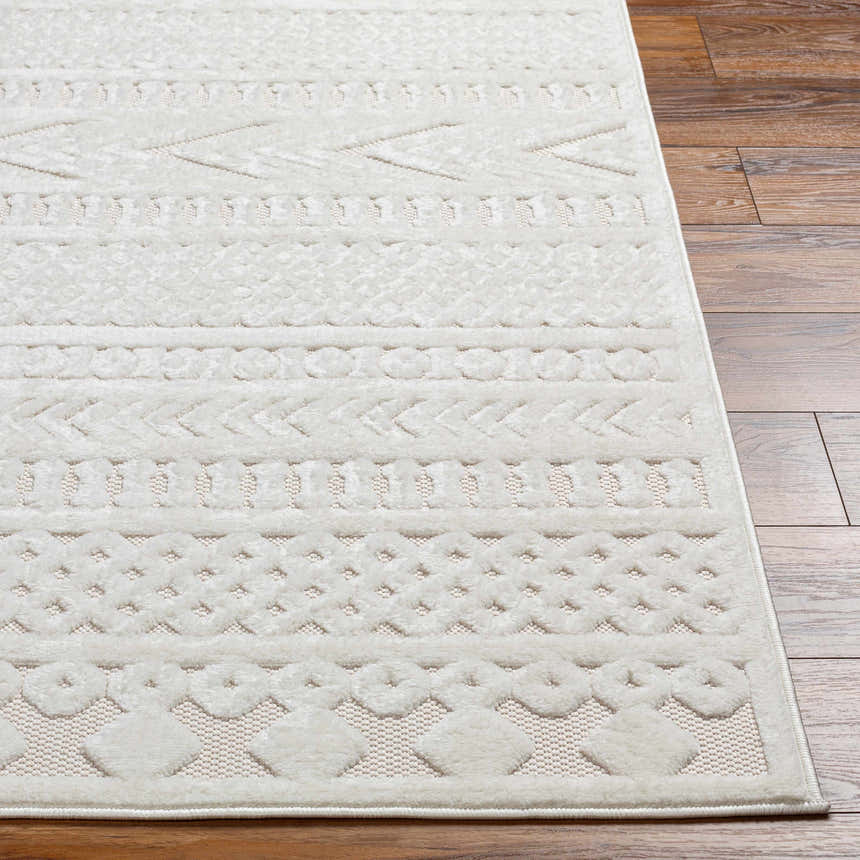 Close-up of Jove Cream Outdoor Rug showing Southwestern-style geometric pattern and soft texture on wood floor. Front