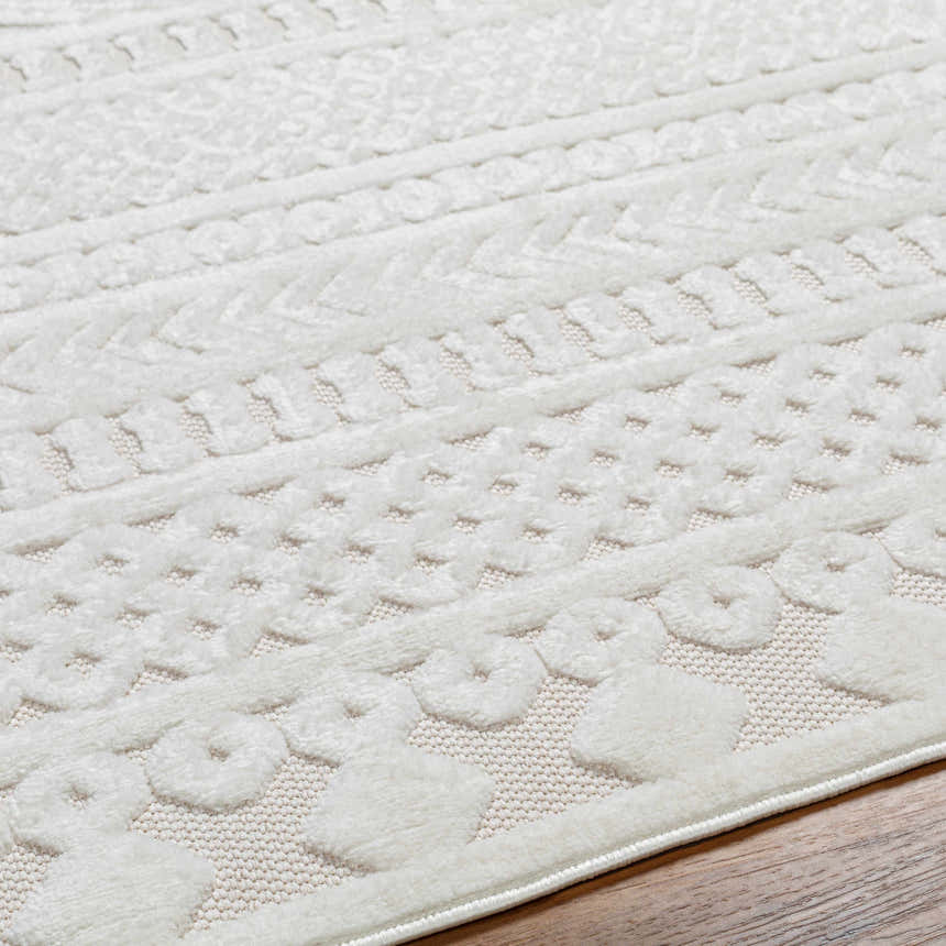Close-up of the Jove Cream Outdoor Rug showing Southwestern-style textured patterns and neutral colors. Texture