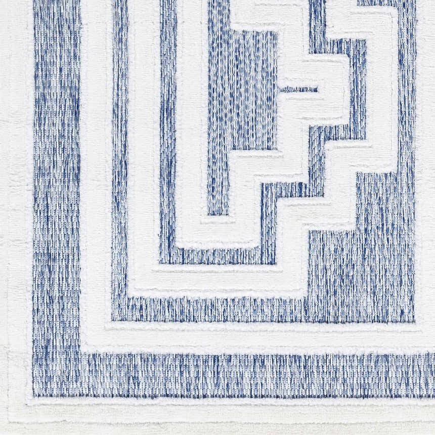 Close-up of the Yves Blue Outdoor Rug featuring a contemporary geometric pattern in textured blue and white. Swatch