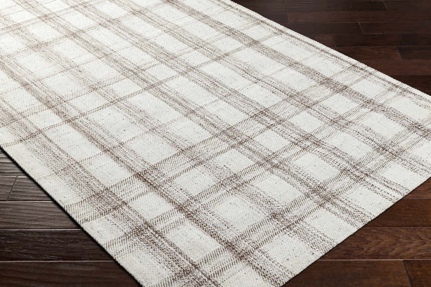 Close up of the Leeba Beige Plaid Area Rug showing its woven texture and farmhouse style pattern on dark wood floors. Corner