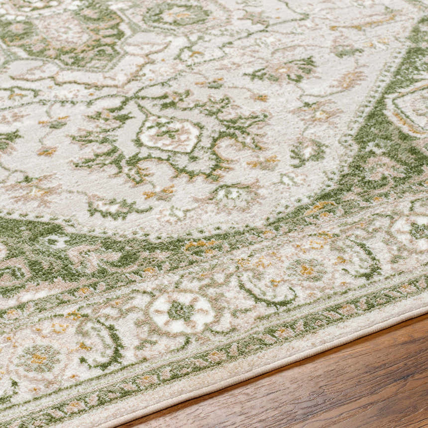 Close-up of Gauri Green Medallion Area Rug showing farmhouse style, floral pattern, and soft texture on wood floor. Texture