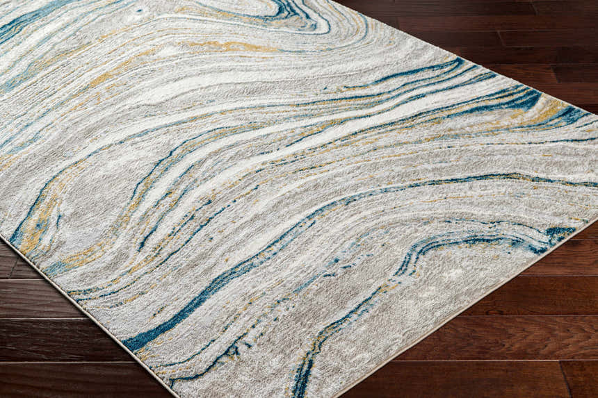 Close-up of Gregg Silver Gray Marble Area Rug showing the marble pattern, blue and gold accents, and soft texture. Corner