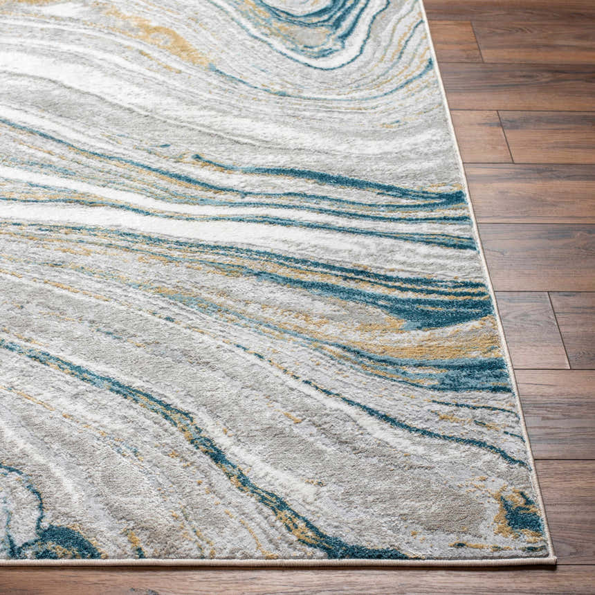 Close-up of Gregg Silver Gray Marble Area Rug showing gray, white, blue, and gold marble-like swirls on dark wood floor. Front