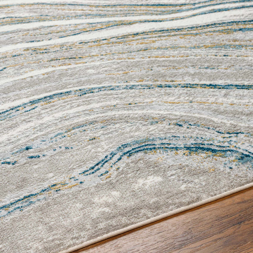 Close-up of the Gregg Silver Gray Marble Area Rug. Features arctic sky, camel, and gray hues in a contemporary marble pattern. Texture
